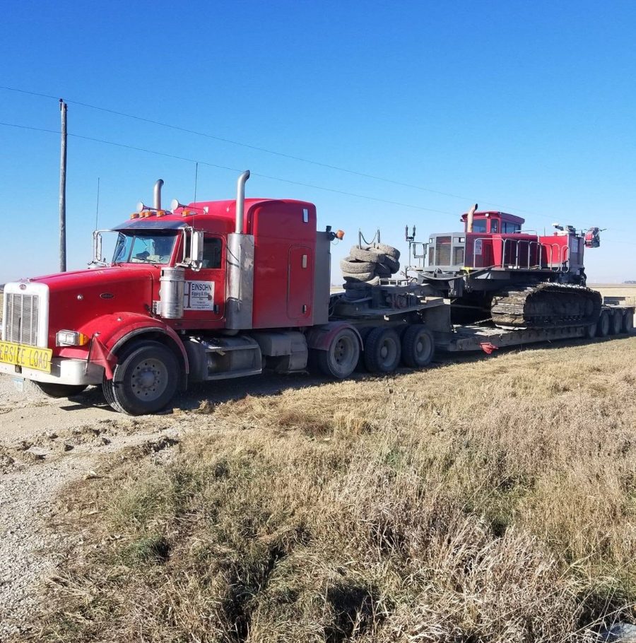 Heinsohn Digging & Tiling truck hauling equipment near Storm Lake, Iowa