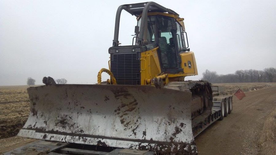 John Deere dozer with 6-way blade loaded for a job site